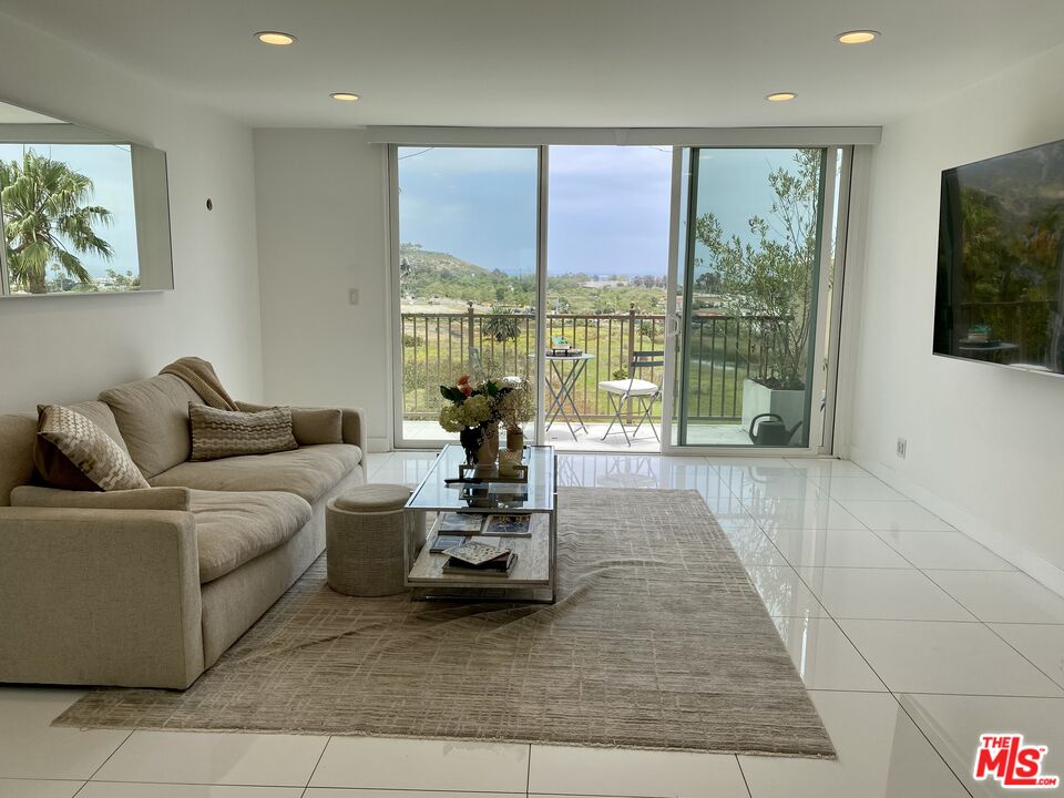 23901 Civic Center Way, Unit 114 Malibu, CA 90265 - Photo 11 of 38 a living room with furniture and large window
