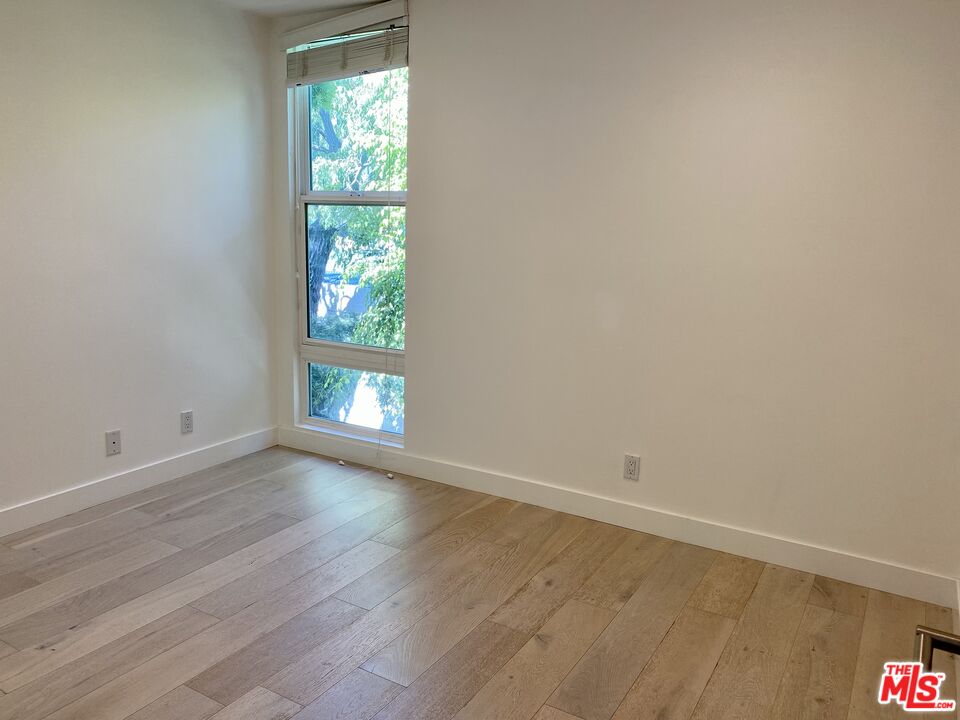 23901 Civic Center Way, Unit 114 Malibu, CA 90265 - Photo 27 of 38 a view of empty room with wooden floor and fan