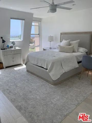 a bedroom with a bed and a lamp