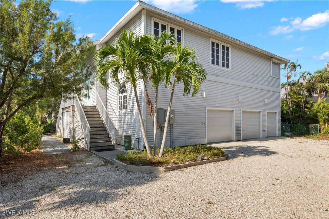 431 Rabbit Road Sanibel, FL 33957 - Photo 1 of 41 a front view of a house with a yard and garage