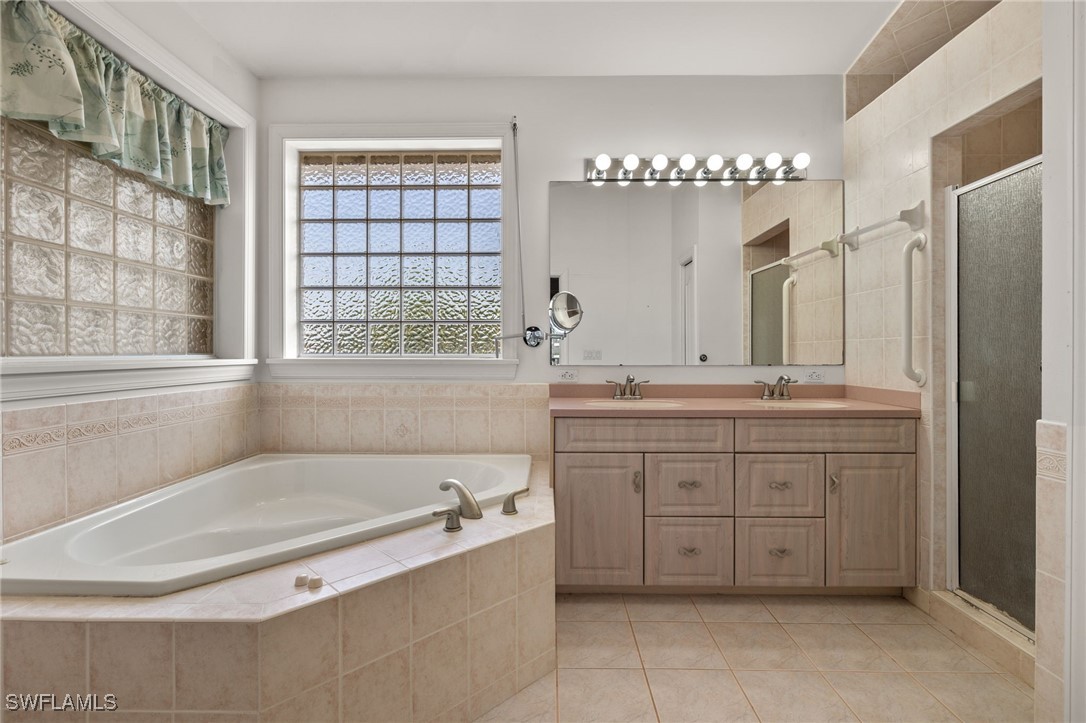 431 Rabbit Road Sanibel, FL 33957 - Photo 13 of 41 a spacious bathroom with a tub sink and mirror