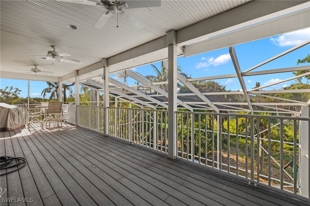 431 Rabbit Road Sanibel, FL 33957 - Photo 21 of 41 a view of a balcony with furniture and wooden floor