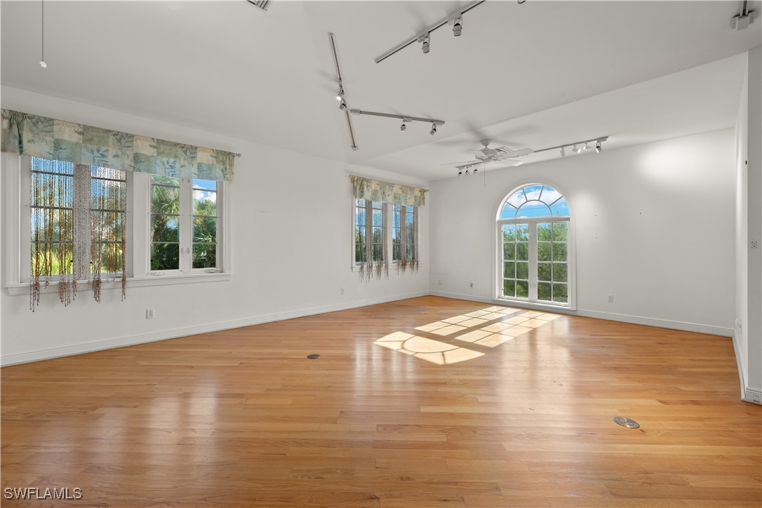 431 Rabbit Road Sanibel, FL 33957 - Photo 3 of 41 a view of empty room with wooden floor and fan