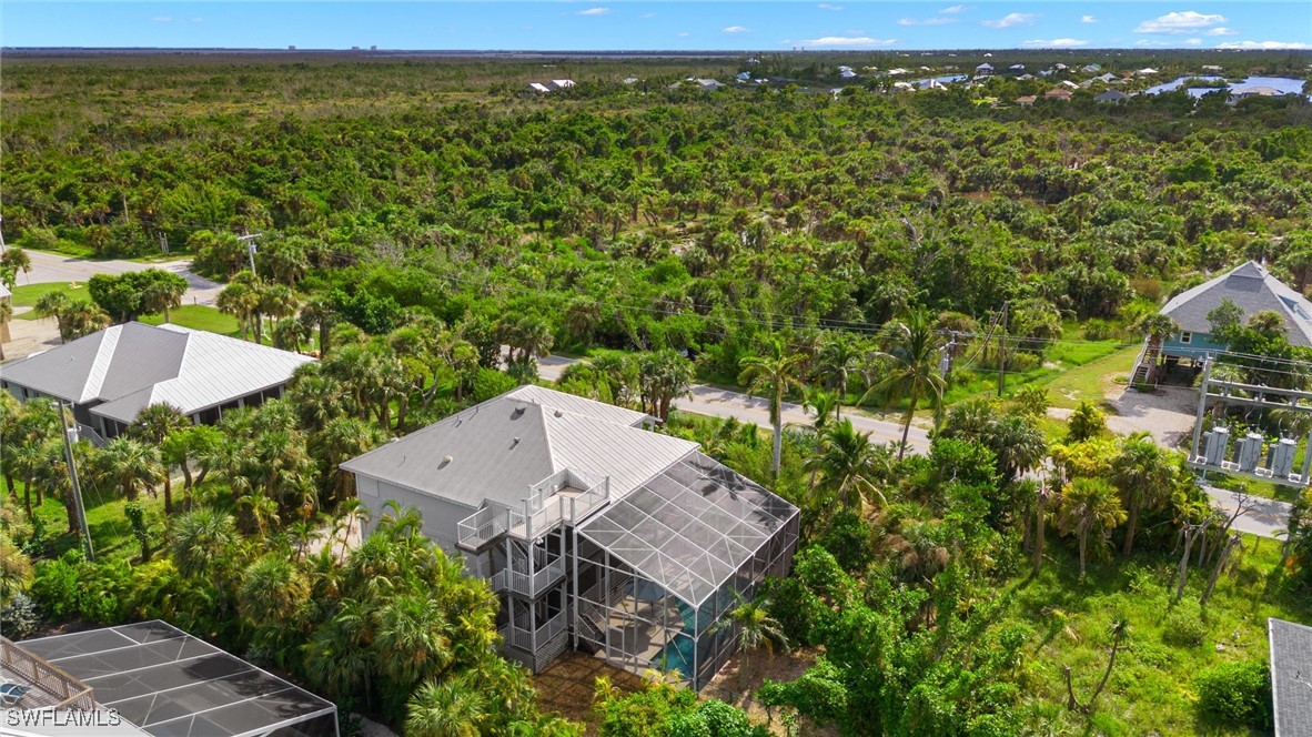 431 Rabbit Road Sanibel, FL 33957 - Photo 39 of 41 a view of a garden with a building in the background