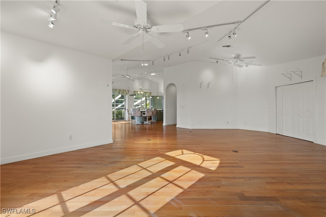431 Rabbit Road Sanibel, FL 33957 - Photo 5 of 41 an empty room with wooden floor and outdoor space