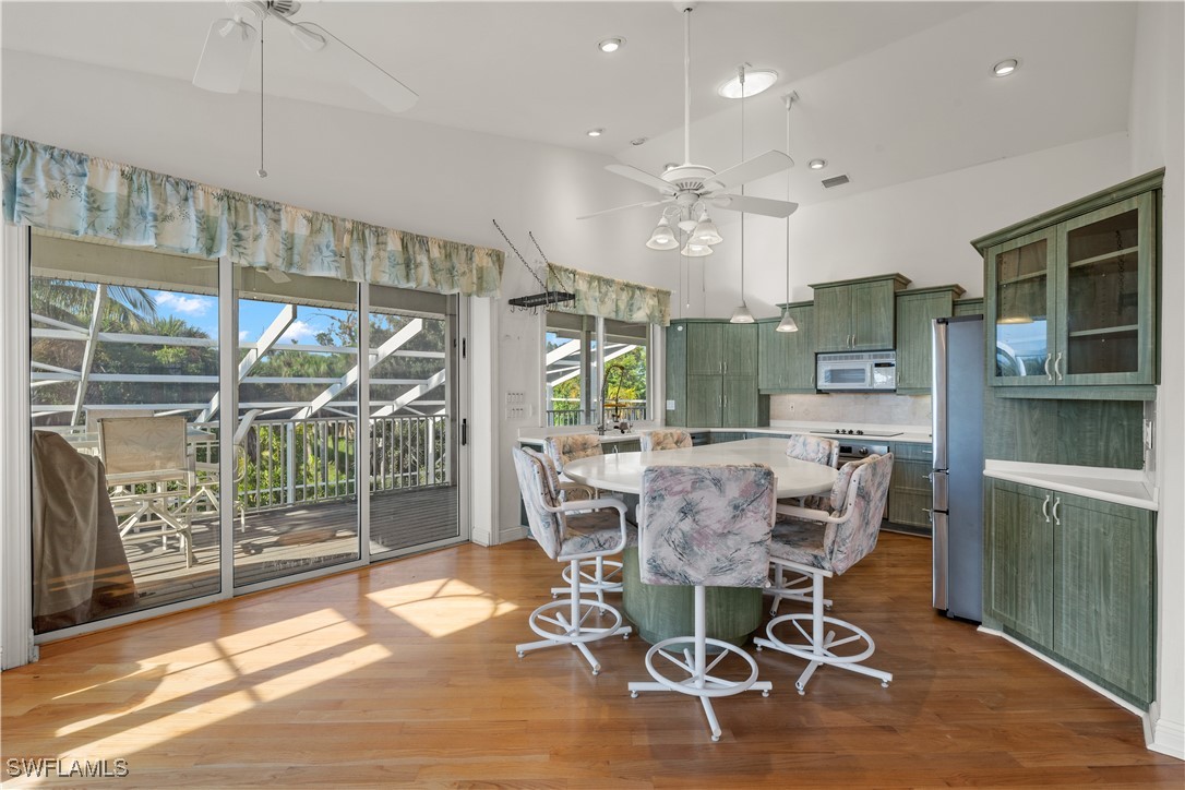 431 Rabbit Road Sanibel, FL 33957 - Photo 10 of 41 a dining room with furniture a chandelier and wooden floor