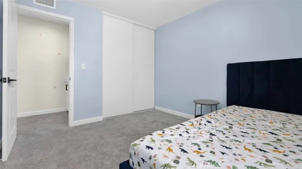 a view of a bedroom with closet and wooden floor