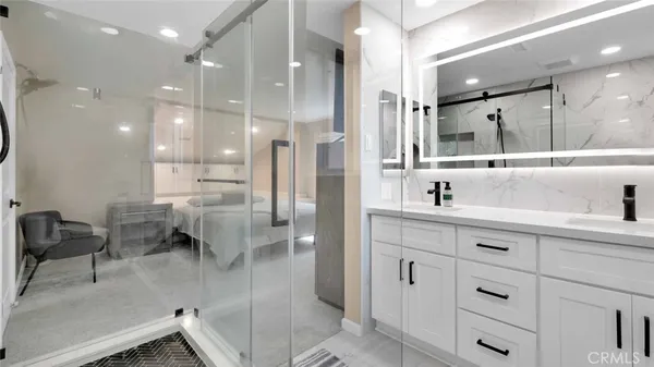 a bathroom with a toilet a sink a mirror and vanity