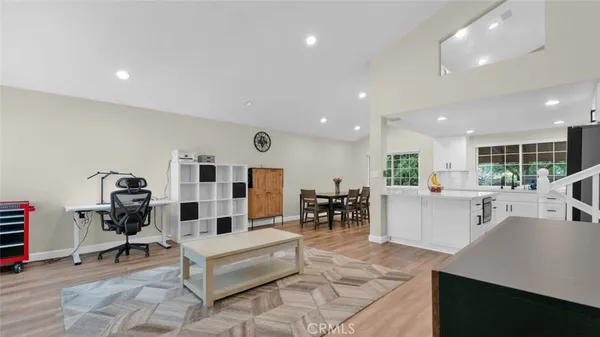 a living room with furniture a dining table and kitchen view