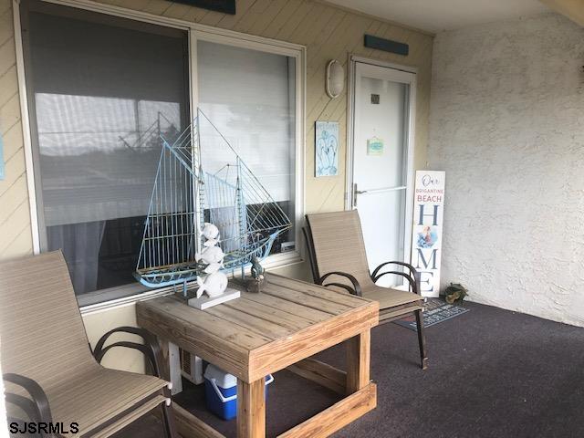 203 East Brigantine Avenue, Unit 206 Brigantine, NJ 08203 - Photo 3 of 14 a table and chairs in a room