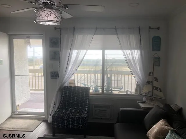 a living room with furniture and a floor to ceiling window