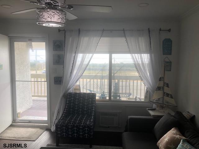 203 East Brigantine Avenue, Unit 206 Brigantine, NJ 08203 - Photo 5 of 14 a living room with furniture and a floor to ceiling window