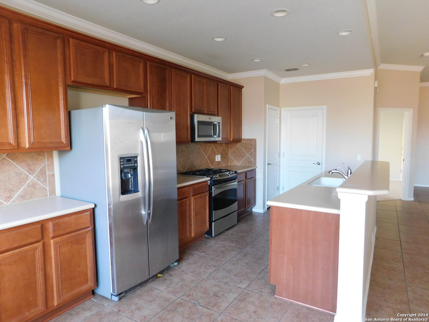 26907 Bluewater Way San Antonio, TX 78260 - Photo 5 of 13 a kitchen with stainless steel appliances a refrigerator and a stove top oven