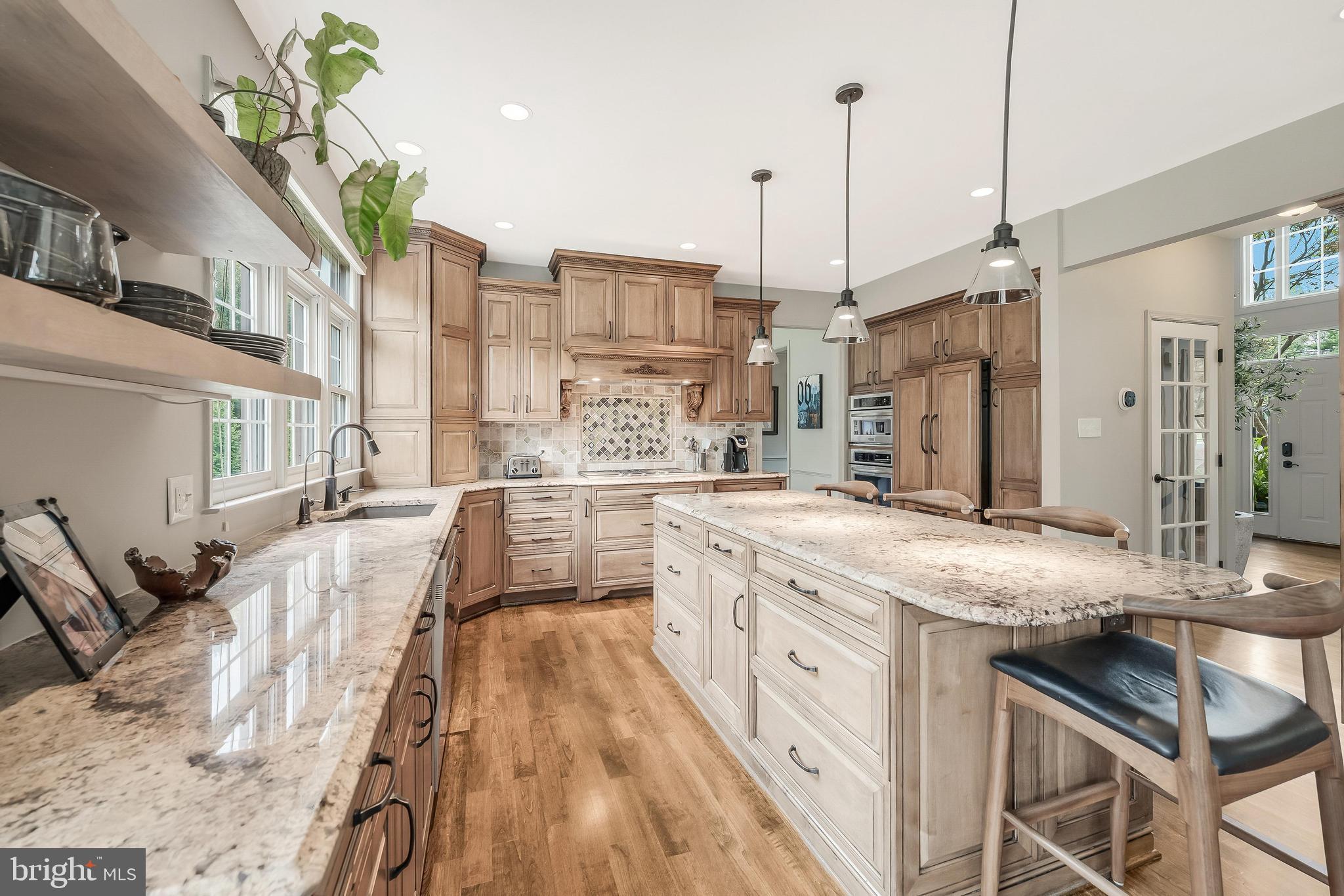 1179 Reston Avenue Herndon, VA 20194 - Photo 16 of 47 a large kitchen with stainless steel appliances granite countertop a lot of counter space and a wooden floors