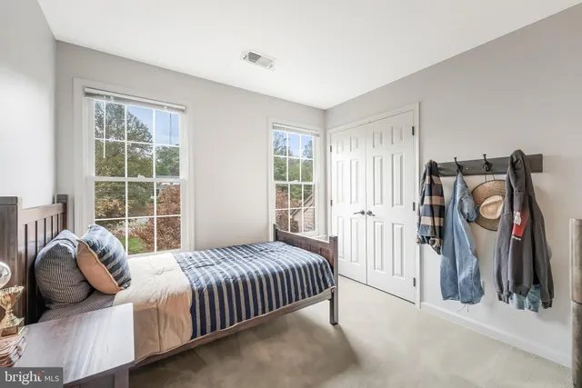 a bedroom with a bed next to a window