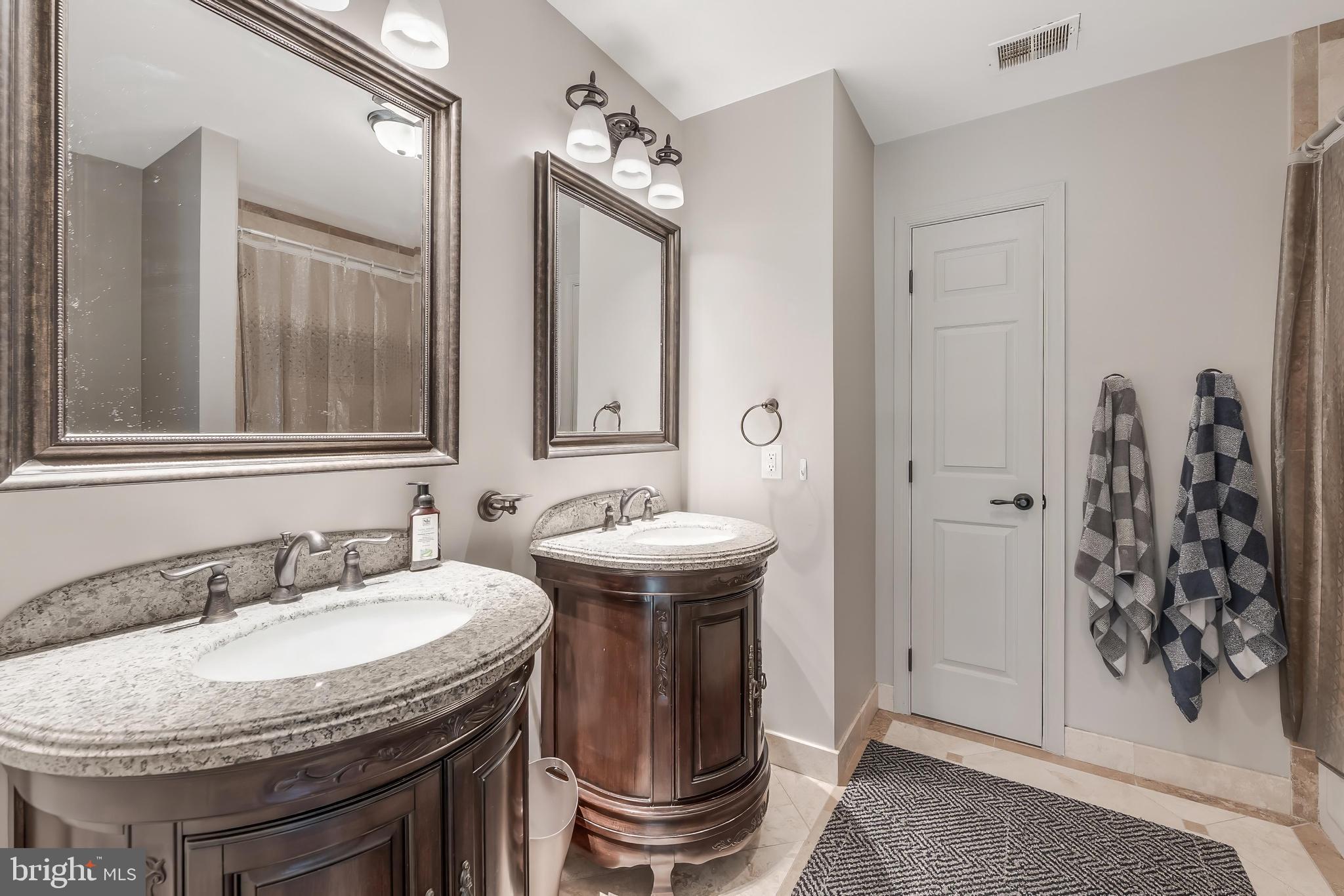 1179 Reston Avenue Herndon, VA 20194 - Photo 28 of 47 a bathroom with a granite countertop sink and a mirror