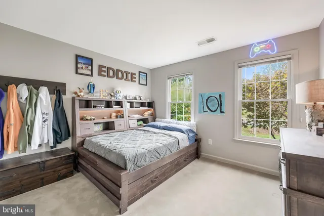 a bed room with a bed and a chair