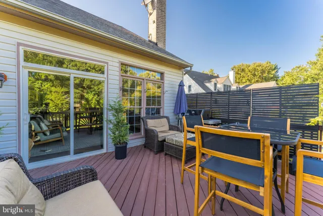 a view of a balcony with chairs and wooden floor