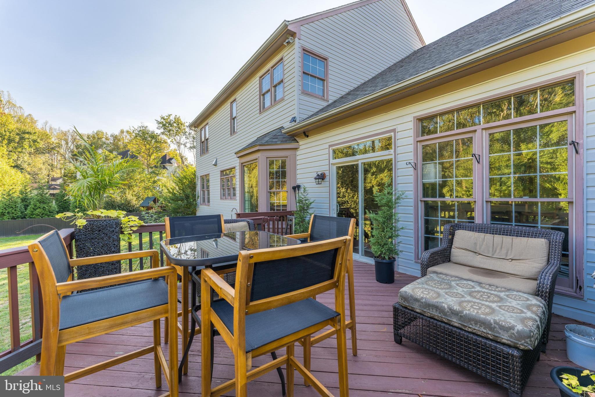 1179 Reston Avenue Herndon, VA 20194 - Photo 39 of 47 a view of a patio with couches potted plants and wooden floor