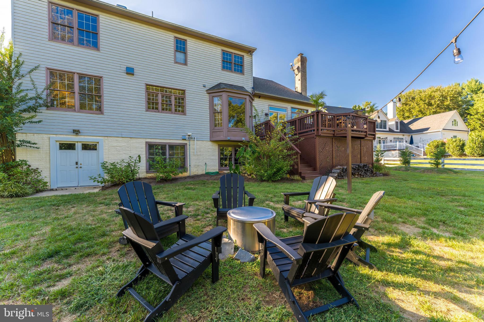 1179 Reston Avenue Herndon, VA 20194 - Photo 41 of 47 a view of a backyard with chairs potted plants and a large tree