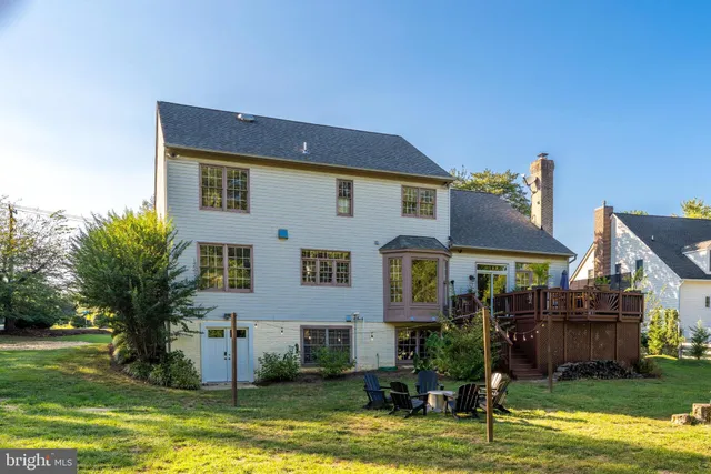 a front view of a house with a garden and swimming pool