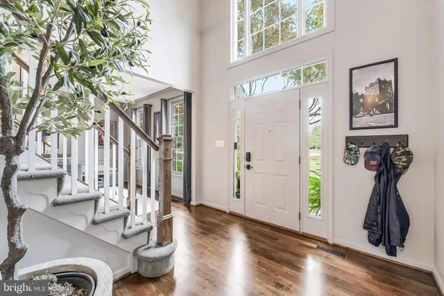 a view of entryway and hall with wooden floor