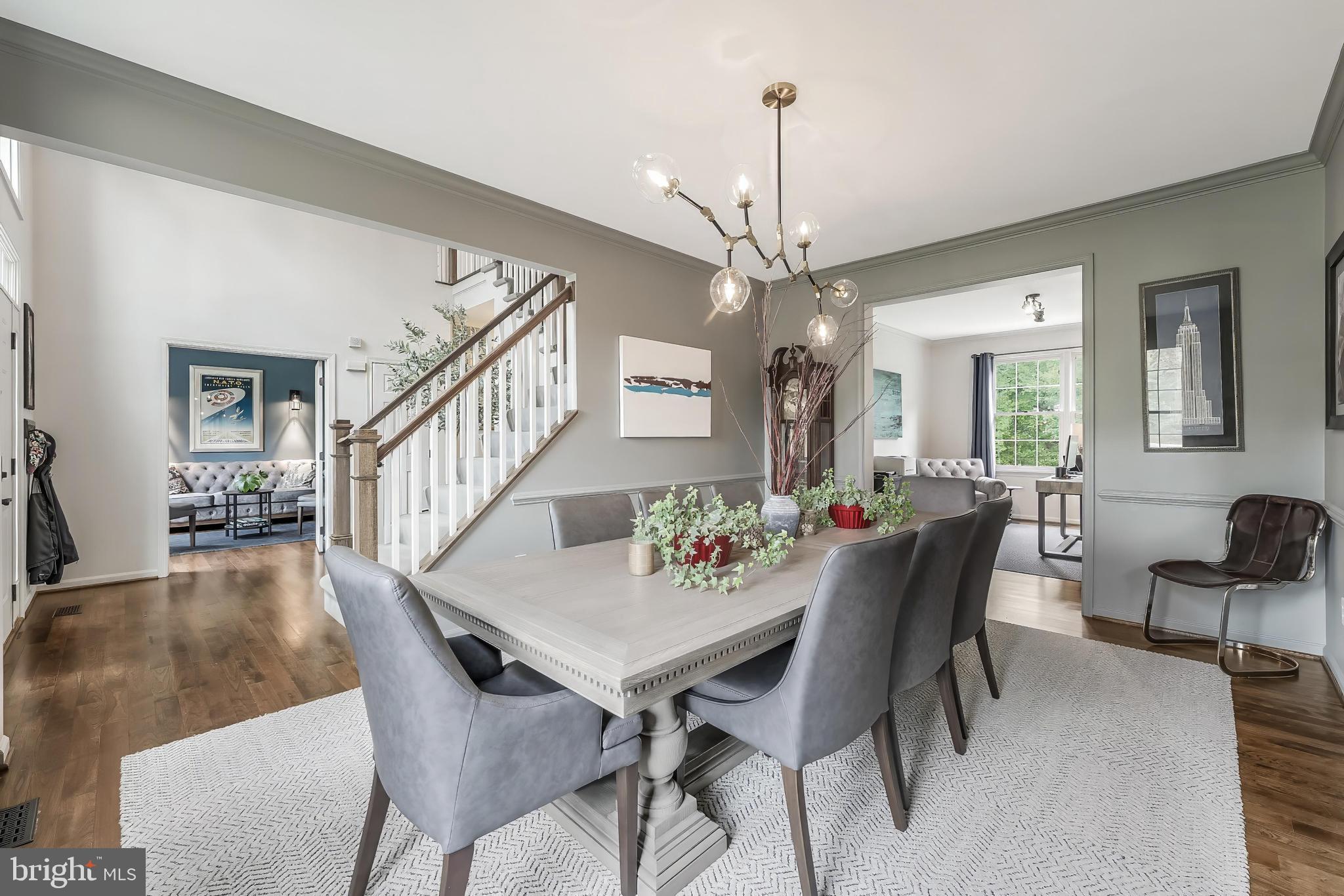 1179 Reston Avenue Herndon, VA 20194 - Photo 8 of 47 a view of a dining room and livingroom with furniture wooden floor a chandelier