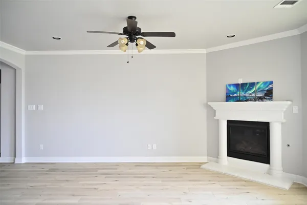 a view of a livingroom with a fireplace and a ceiling fan