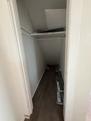 a view of walk in closet with clothes