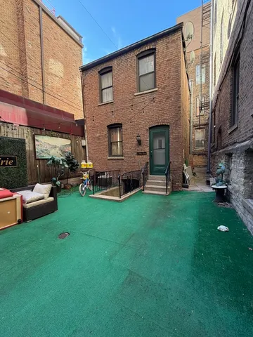 a view of a house with a backyard and a patio
