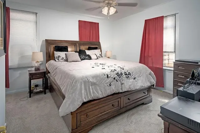 a bedroom with a bed and a window