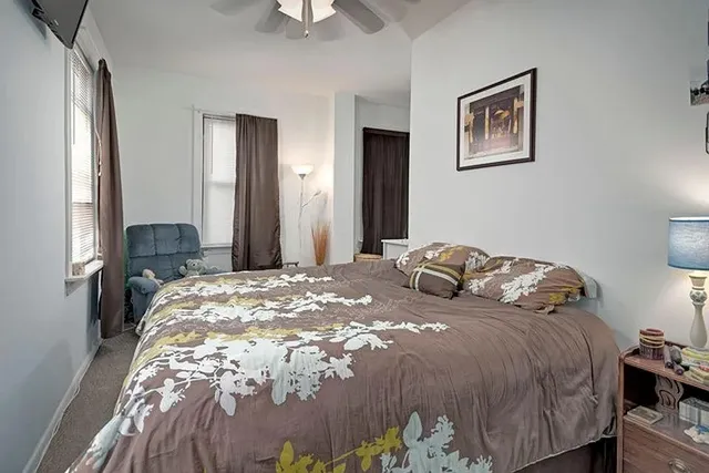 a bedroom with a bed and a dresser