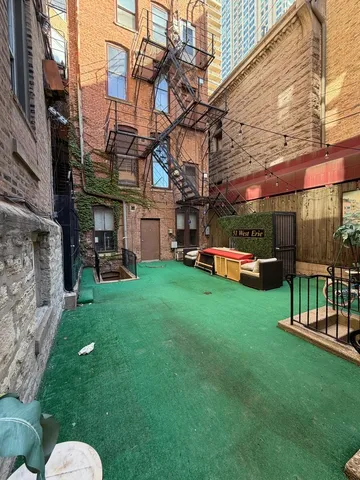 a house view with a sitting space and garden