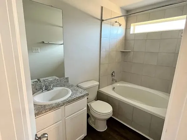 a bathroom with a sink a toilet a bathtub and shower