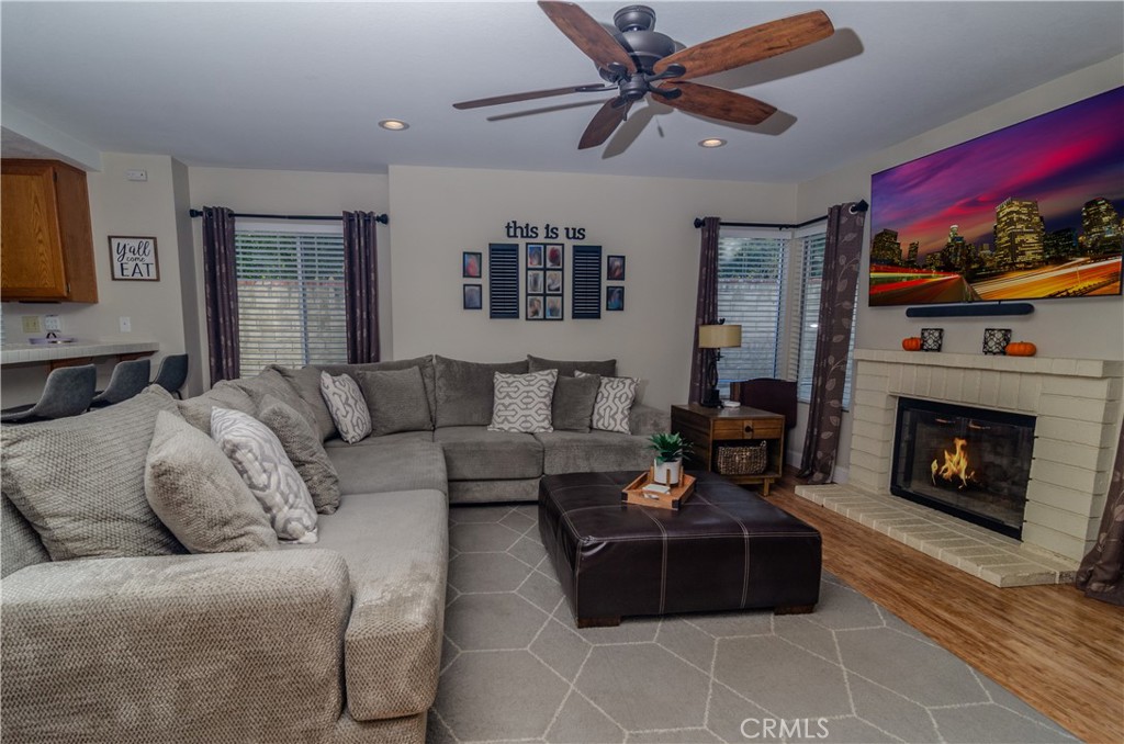 27625 Moonlight Place Castaic, CA 91384 - Photo 14 of 72 a living room with furniture a fireplace and a flat screen tv