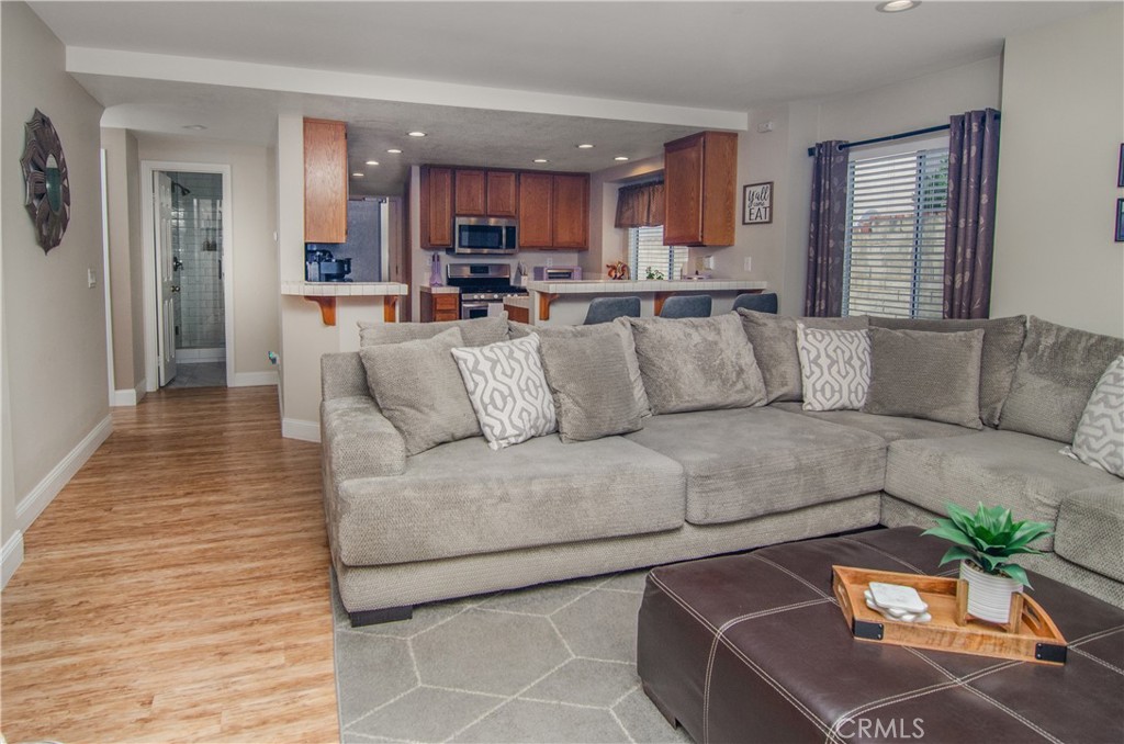 27625 Moonlight Place Castaic, CA 91384 - Photo 16 of 72 a living room with furniture and a dining table with kitchen view