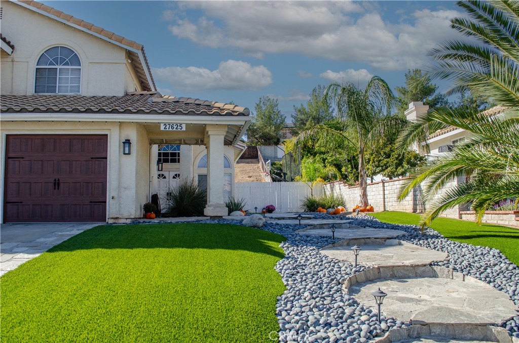 27625 Moonlight Place Castaic, CA 91384 - Photo 2 of 72 a front view of a house with a yard