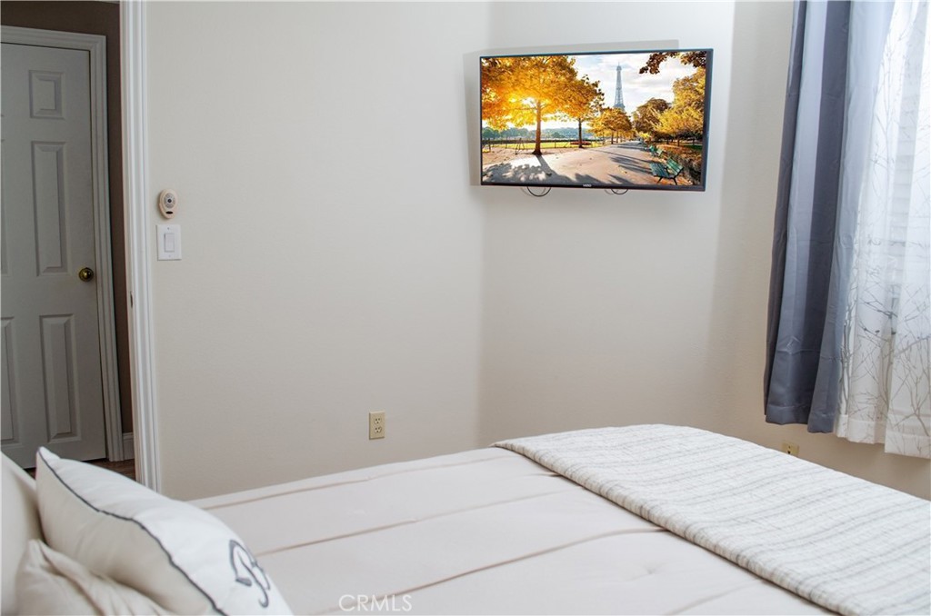 27625 Moonlight Place Castaic, CA 91384 - Photo 23 of 72 a bedroom with a bed and a flat screen tv