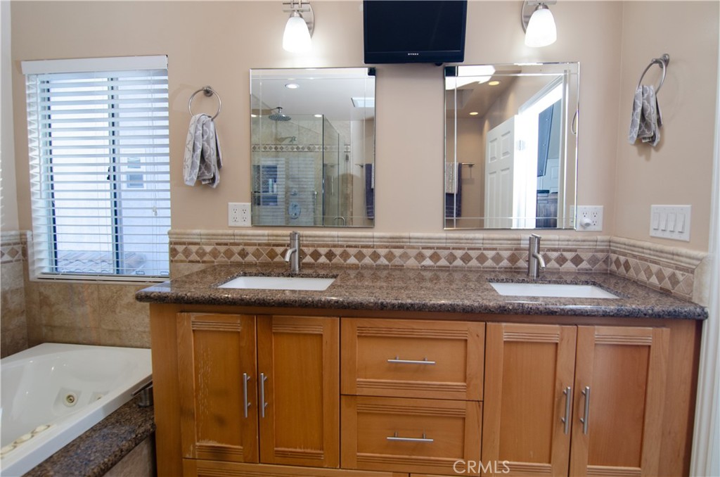 27625 Moonlight Place Castaic, CA 91384 - Photo 37 of 72 a bathroom with a granite countertop sink and a mirror