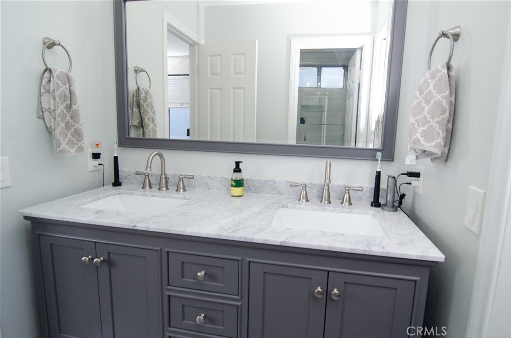 27625 Moonlight Place Castaic, CA 91384 - Photo 43 of 72 a bathroom with a granite countertop sink and a mirror
