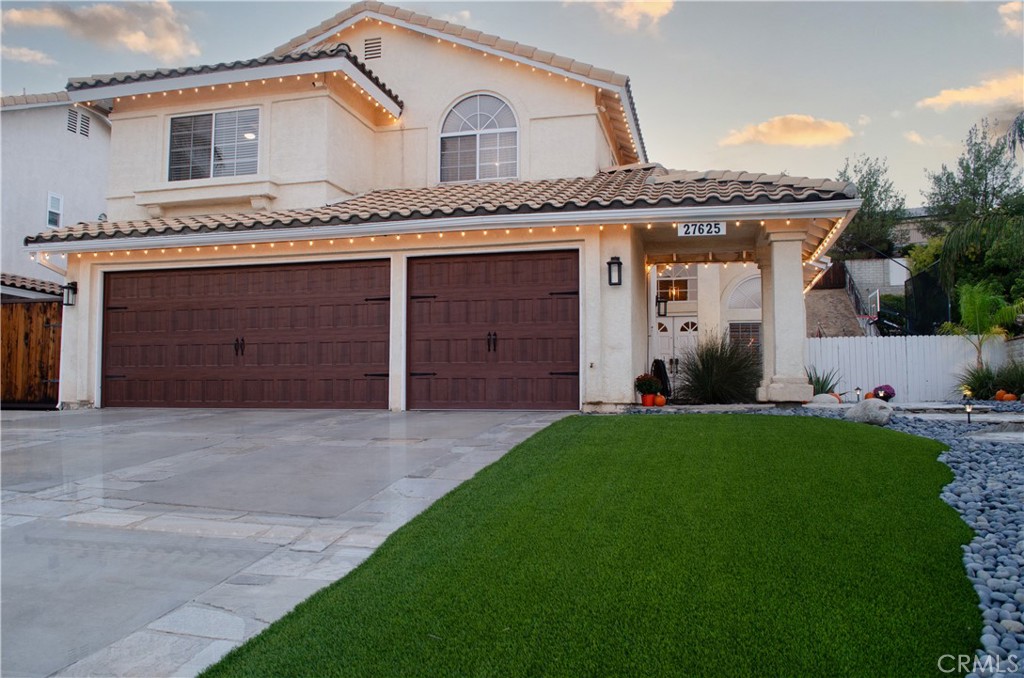 27625 Moonlight Place Castaic, CA 91384 - Photo 66 of 72 a front view of a house with a yard and garage