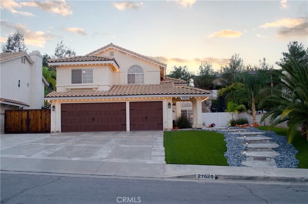 27625 Moonlight Place Castaic, CA 91384 - Photo 67 of 72 a front view of a house with a garden and garage