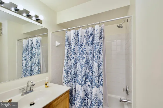 a bathroom with a shower curtain and a sink