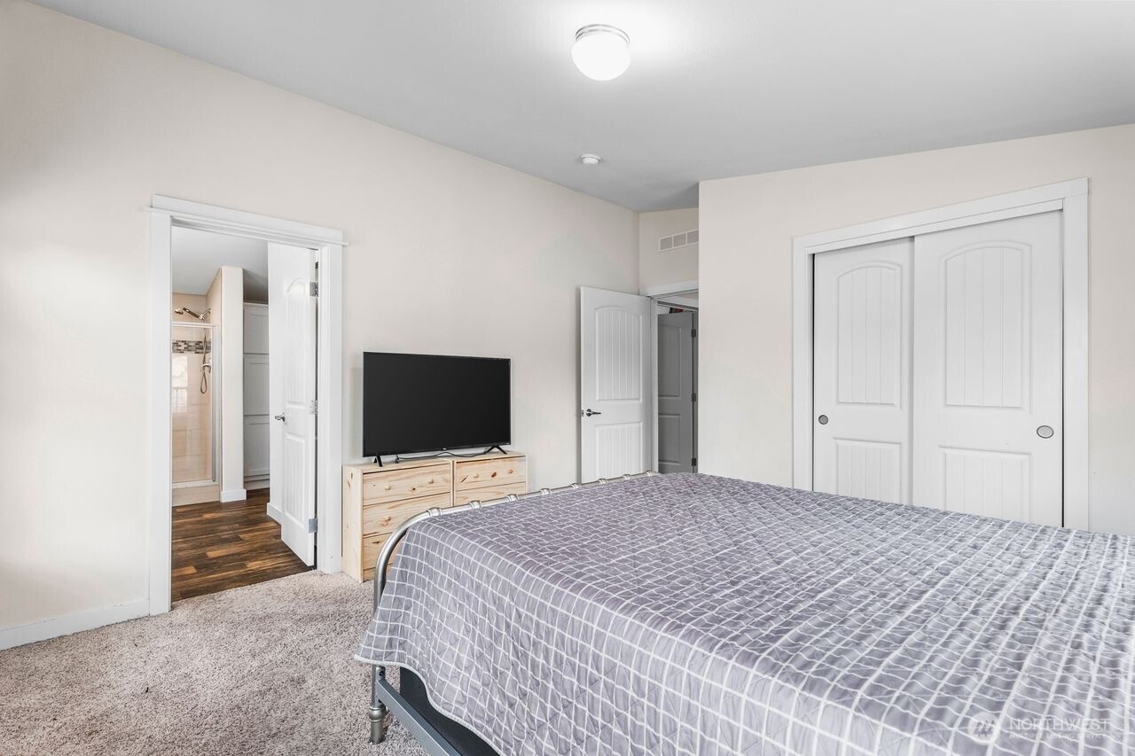 120 L Street Southeast Auburn, WA 98002 - Photo 11 of 20 a bedroom with a bed and a flat screen tv