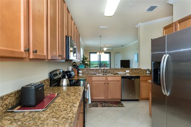 a kitchen with a refrigerator and a stove