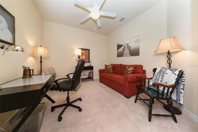 a living room with furniture a lamp and a window