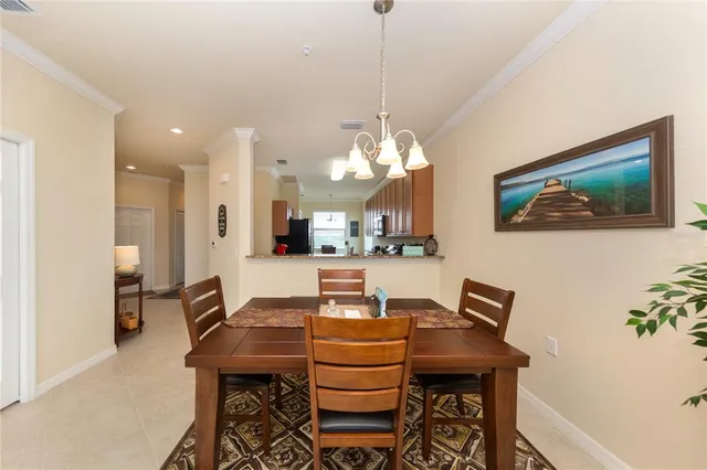 a view of a dining room with furniture and a chandelier
