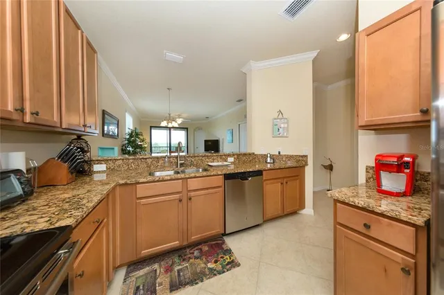 a kitchen with stainless steel appliances granite countertop a sink stove and cabinets