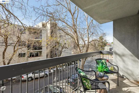 a balcony with dining table and chairs