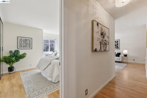 a bedroom with a bed and a potted plant